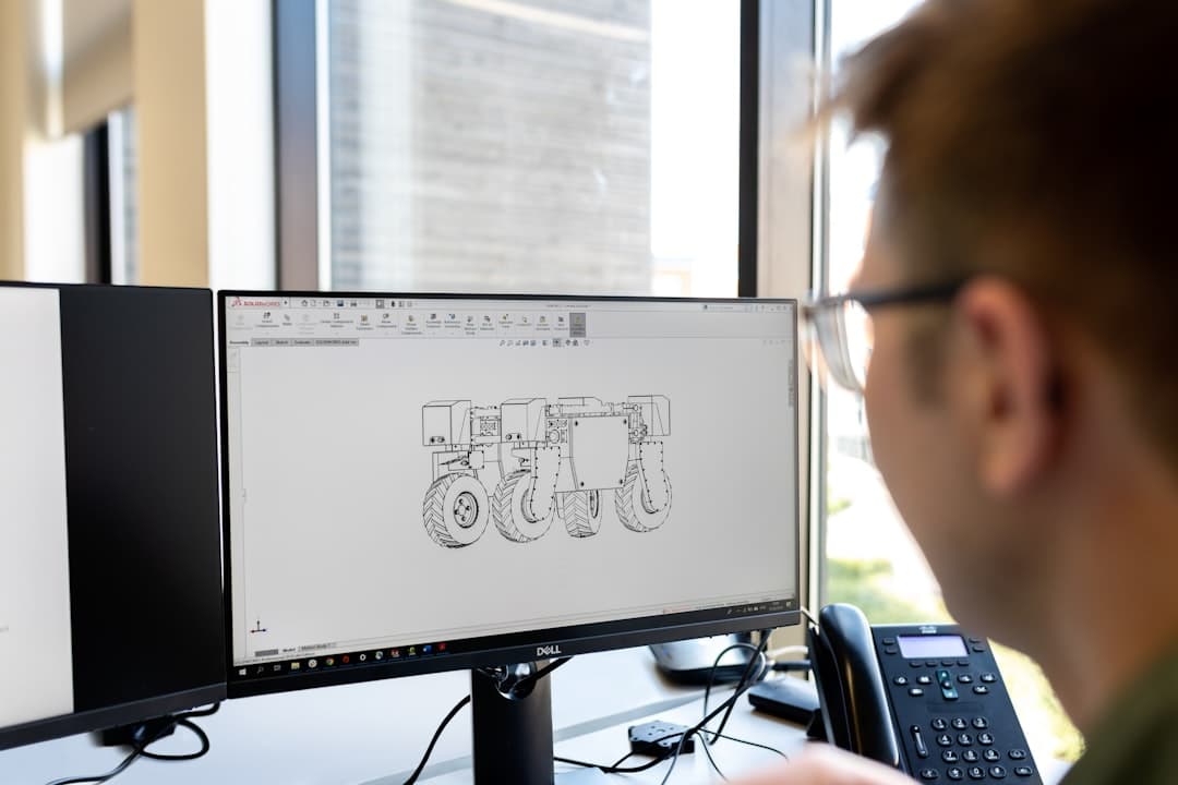 Engineer reviewing a robotics CAD design on screen